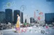 A woman standing on top of a roof next to a bunch of drawings.