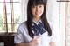 A young woman in a school uniform posing for a picture.